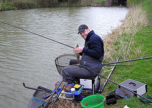 An angler on the Kennet and Avon Canal, Englan...